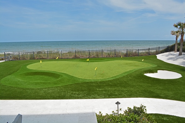 Pittsburgh Synthetic grass golf green by the sea with yellow flags and a sand bunker