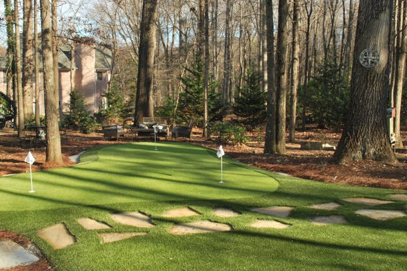 Pittsburgh backyard putting green with flags and trees