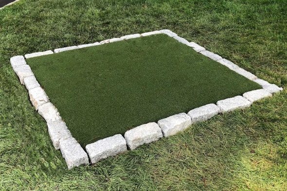 Pittsburgh Tee box made of synthetic grass surrounded by stone border